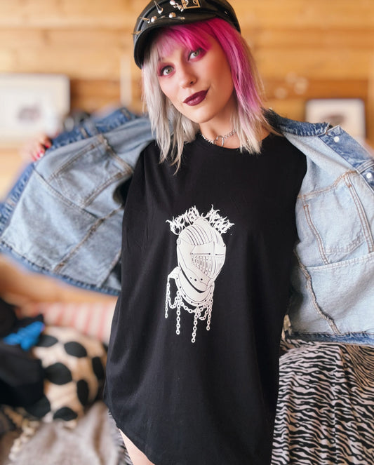Female with pink hair wearing the metal head T-shirt and a denim jacket