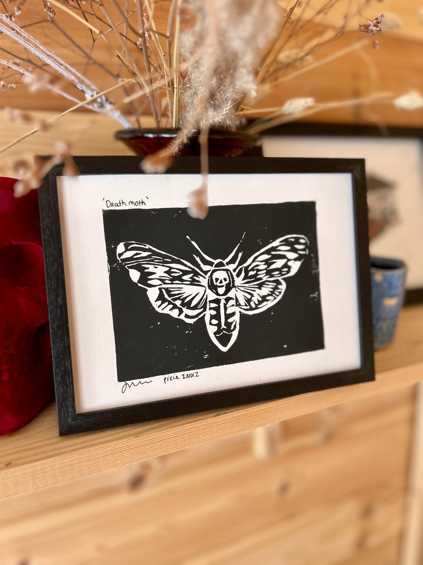 Photo of a moth Lino print in a frame 